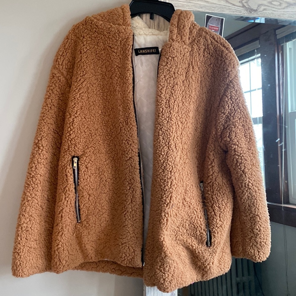 White/Tan Sherpa Jacket. It’s a size Medium and has a big fluffy hood.